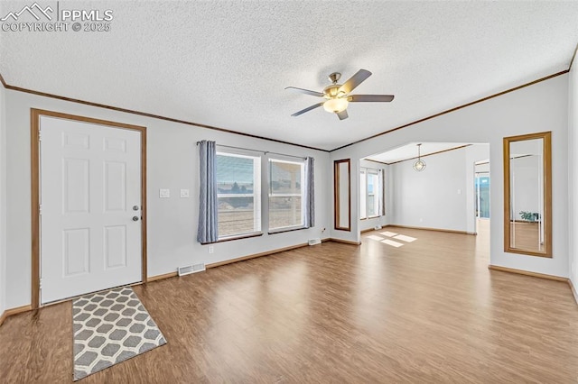 interior space featuring crown molding, visible vents, and wood finished floors