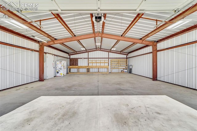 garage featuring metal wall and a garage door opener