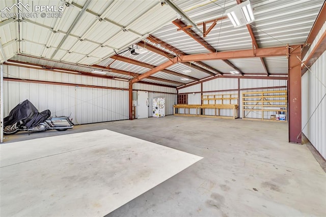 garage with a garage door opener and metal wall