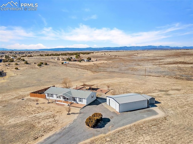 birds eye view of property with view of desert, a rural view, and a mountain view