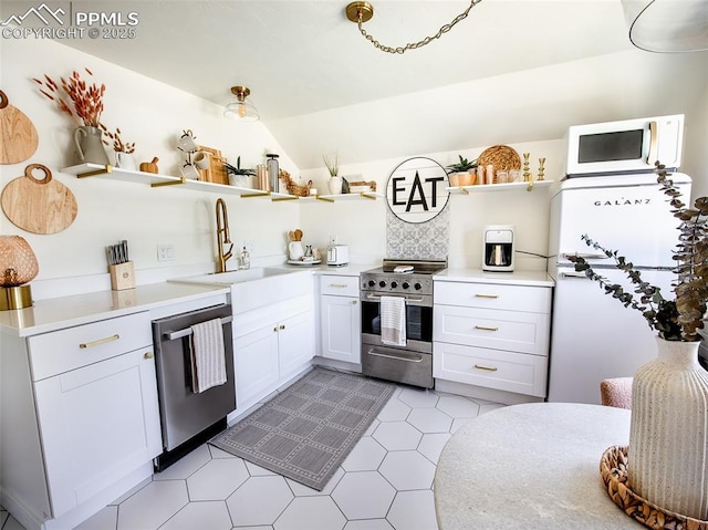 kitchen with stainless steel appliances, a sink, white cabinetry, light countertops, and open shelves