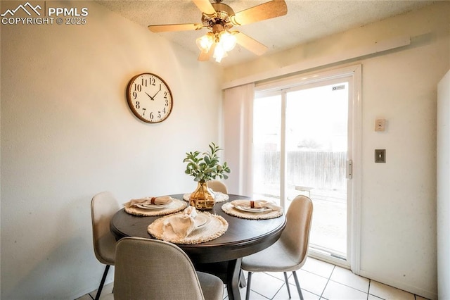 dining room with light tile patterned floors, a textured ceiling, and ceiling fan