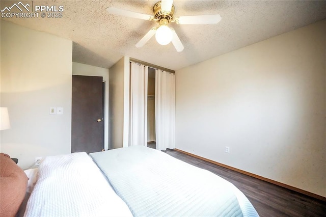 bedroom with a ceiling fan, wood finished floors, a closet, and a textured ceiling