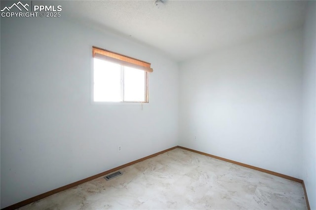 unfurnished room featuring visible vents and baseboards