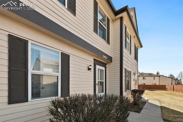 view of home's exterior featuring fence