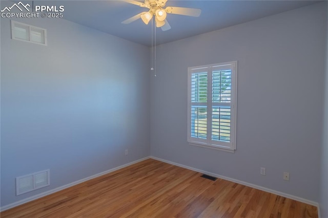 empty room featuring light wood-style flooring, visible vents, and a ceiling fan