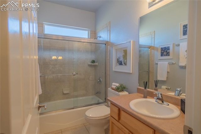 bathroom featuring toilet, tile patterned floors, shower / bath combination with glass door, and vanity