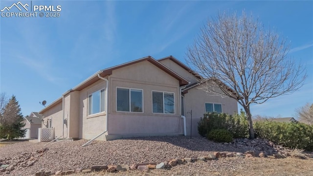 view of side of property with stucco siding