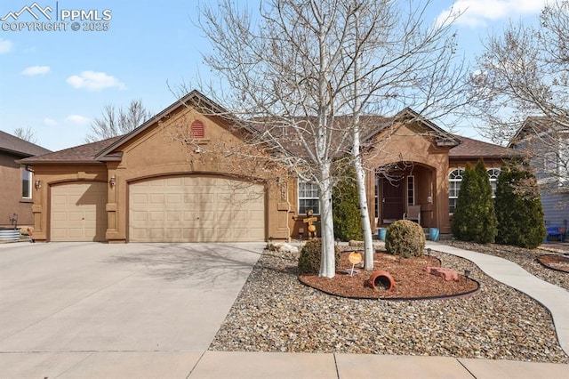 ranch-style home with a garage, concrete driveway, and stucco siding