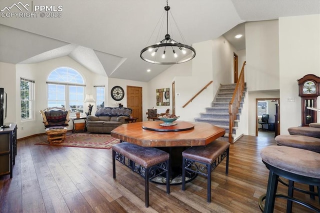 dining area with stairs, high vaulted ceiling, and dark wood-type flooring