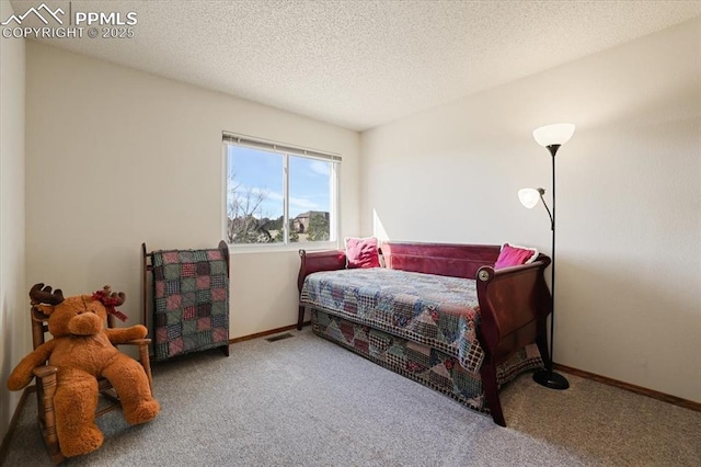 bedroom featuring carpet, visible vents, a textured ceiling, and baseboards