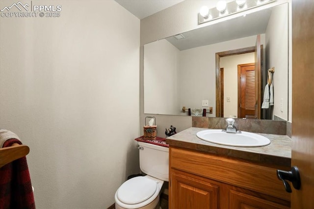 bathroom featuring vanity and toilet