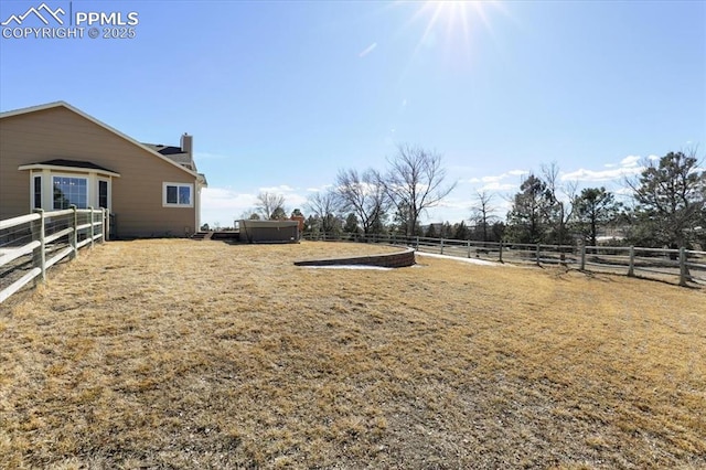 view of yard featuring an enclosed area and fence