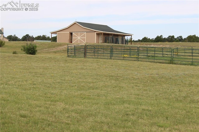 view of horse barn with a rural view