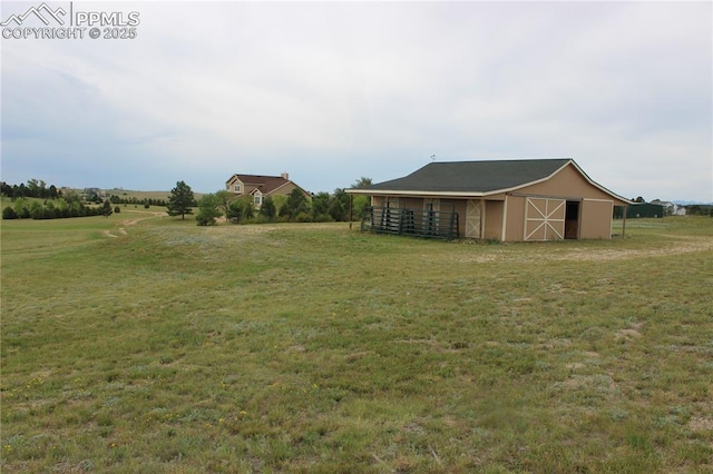 view of yard with a rural view, an outdoor structure, and a barn