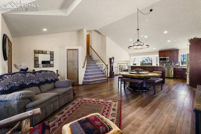 living area with stairs, high vaulted ceiling, dark wood-style flooring, and recessed lighting