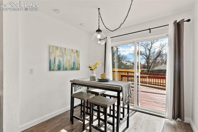 dining room with wood finished floors and baseboards