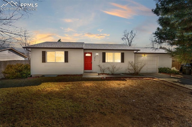 ranch-style home with fence, entry steps, a front yard, driveway, and an attached garage