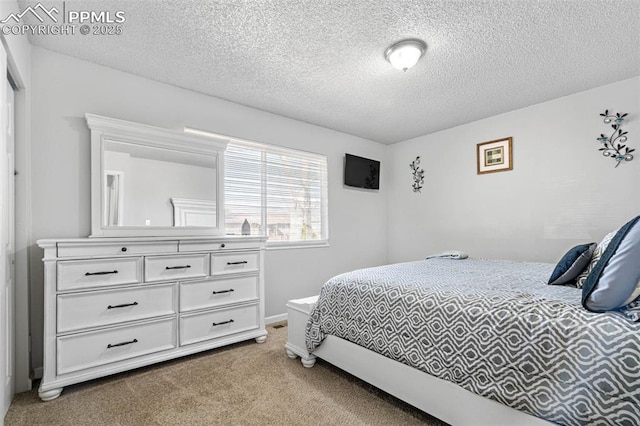 bedroom featuring a textured ceiling and carpet flooring