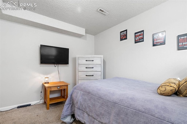 bedroom with baseboards, visible vents, a textured ceiling, and carpet