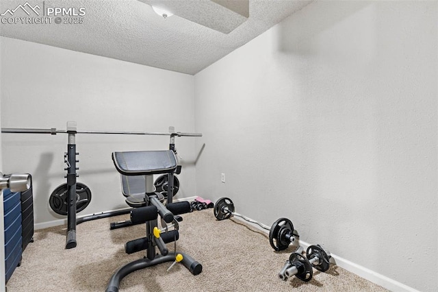 workout room with baseboards and a textured ceiling