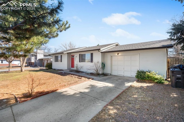 ranch-style house featuring an attached garage, fence, and driveway