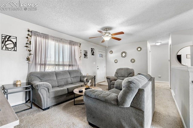 living area featuring baseboards, light carpet, a textured ceiling, and a ceiling fan