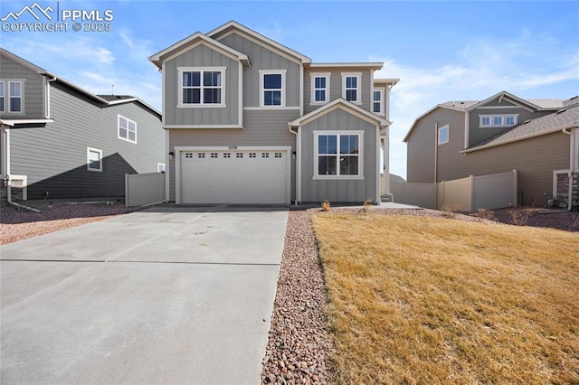 view of front of house featuring concrete driveway, an attached garage, board and batten siding, fence, and a front lawn