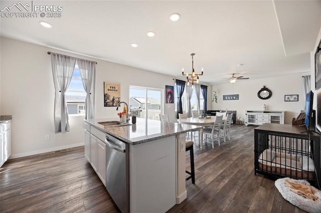 kitchen with a sink, white cabinetry, dark wood-style flooring, and dishwasher