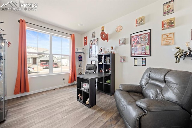 living area with baseboards and light wood-style floors