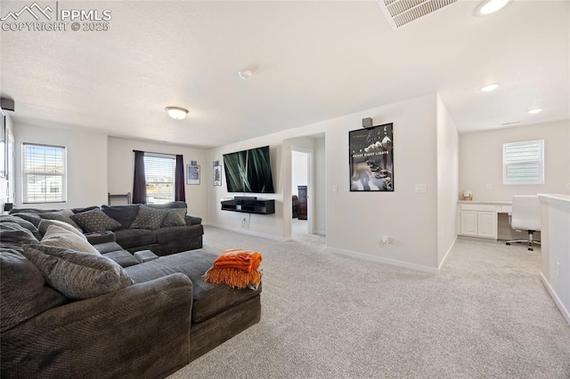 living room with light carpet, baseboards, visible vents, built in desk, and recessed lighting