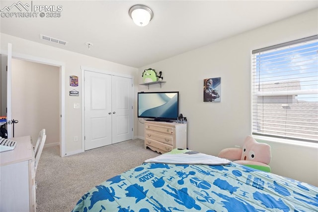 bedroom featuring light carpet, a closet, visible vents, and baseboards