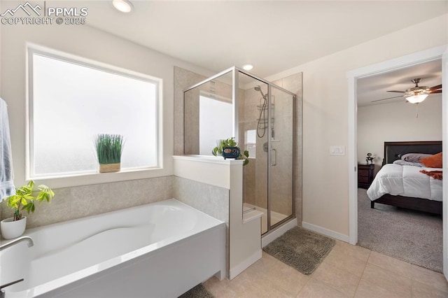 ensuite bathroom with tile patterned flooring, connected bathroom, a bath, and a shower stall