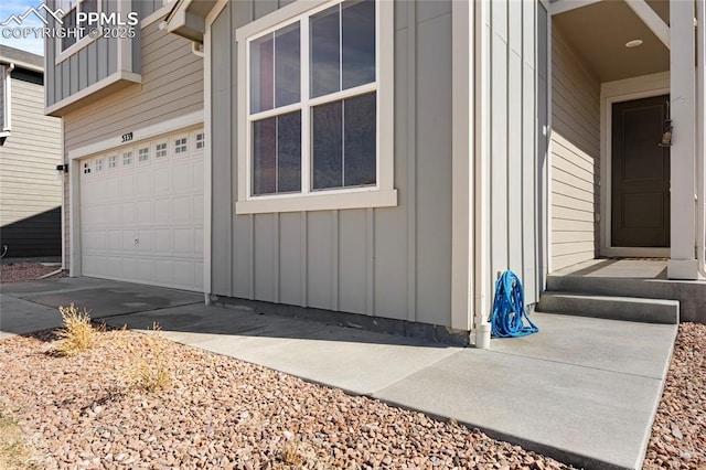 view of side of home featuring a garage and board and batten siding