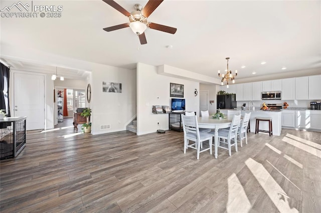 dining area featuring recessed lighting, visible vents, wood finished floors, baseboards, and stairs