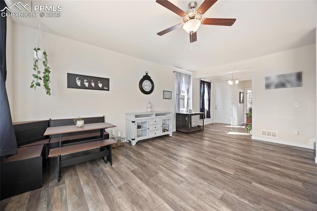 dining area featuring ceiling fan, wood finished floors, visible vents, and baseboards