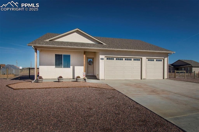 ranch-style home featuring driveway, a shingled roof, an attached garage, and stucco siding