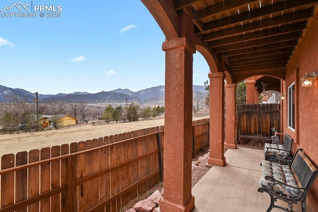 view of patio with a fenced backyard and a mountain view