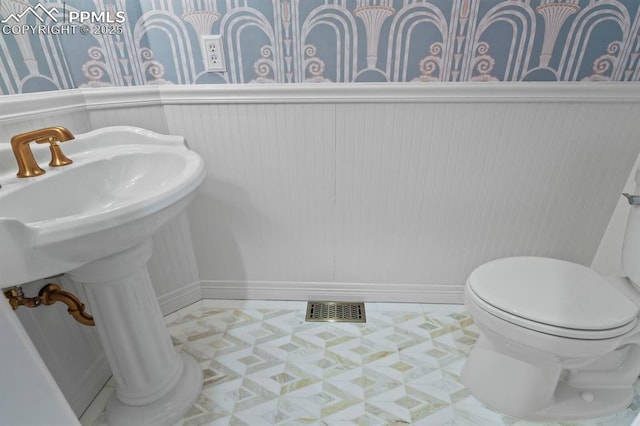 bathroom with toilet and visible vents