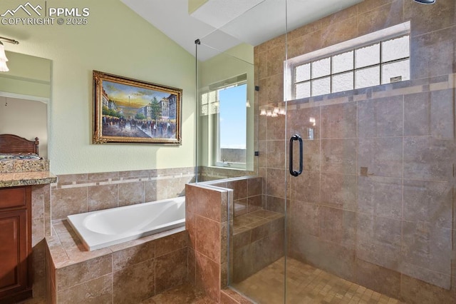 full bath featuring a stall shower, vaulted ceiling, a garden tub, and plenty of natural light