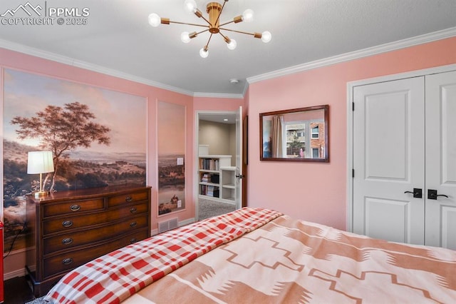 bedroom with a notable chandelier, visible vents, ornamental molding, and a closet