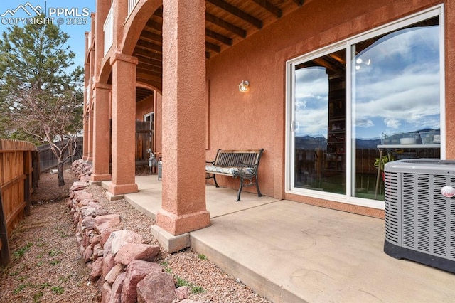 view of patio with a fenced backyard and central air condition unit