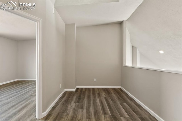 unfurnished room with baseboards and wood finished floors