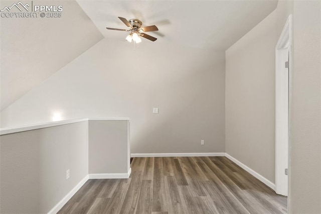 additional living space featuring vaulted ceiling, ceiling fan, baseboards, and wood finished floors