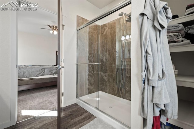 1086 N Purcell Blvd, Pueblo West, CO 81007 - bathroom with ensuite bathroom, wood finished floors, a ceiling fan, baseboards, and a stall shower