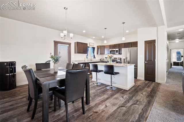1086 N Purcell Blvd, Pueblo West, CO 81007 - dining area featuring recessed lighting, dark wood finished floors, a notable chandelier, and baseboards