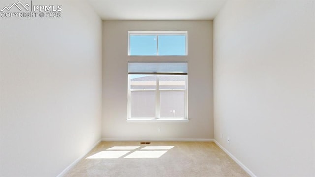 unfurnished room with carpet floors and baseboards