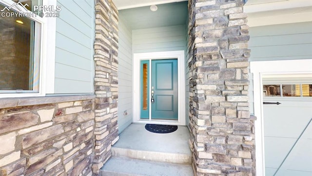 doorway to property featuring stone siding