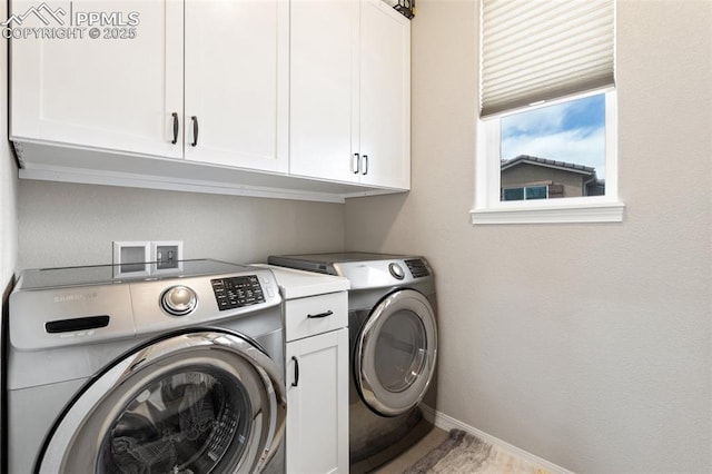 washroom with washing machine and dryer, cabinet space, and baseboards