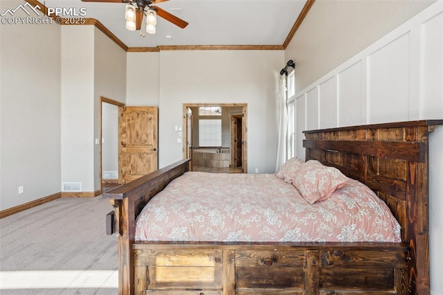 carpeted bedroom featuring baseboards, a high ceiling, visible vents, and crown molding